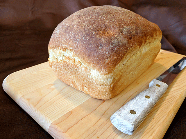 Crusty sourdough cottage bread on cutting board
