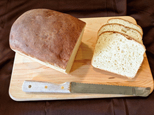 Crusty sourdough cottage bread on a cutting board