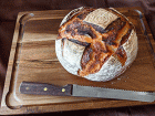 sourdough discard bread on cutting board with bread knife
