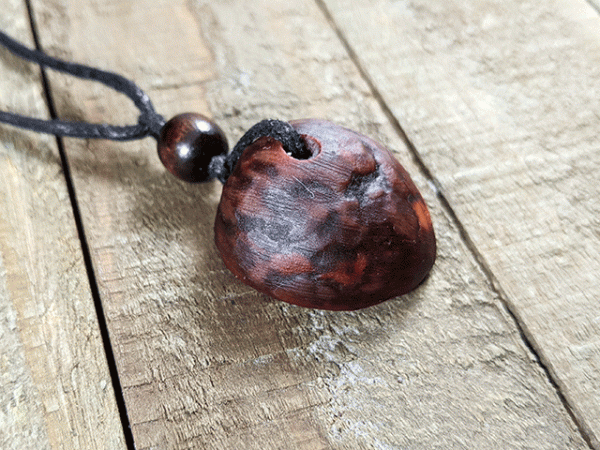 hand-carved avocado stone necklace with hidden heart