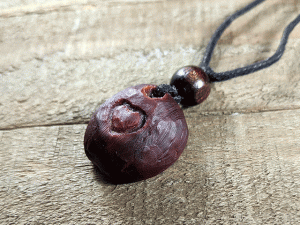 hand-carved avocado stone necklace with heart pattern