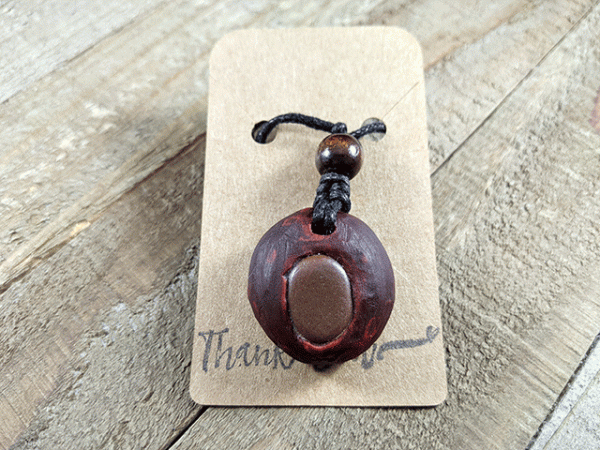 hand-carved avocado stone necklace with tumbled river stone