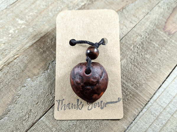 hand-carved avocado stone necklace with hidden heart