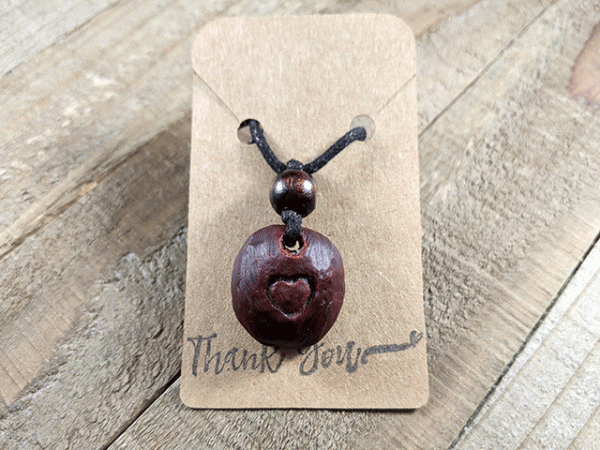 hand-carved avocado stone necklace with heart pattern
