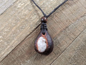 hand-carved avocado stone necklace with river stone
