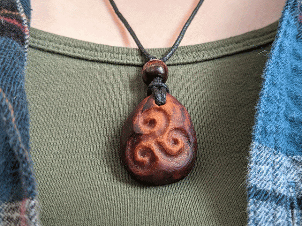 hand-carved avocado stone necklace with triskele
