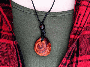 hand-carved avocado stone necklace with double spiral