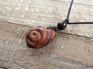 hand-carved avocado stone necklace with bullseye pattern