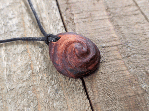 Hand-carved avocado stone necklace with double spiral