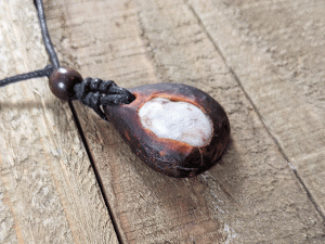 hand-carved avocado stone necklace with river stone