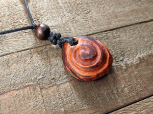 hand-carved avocado stone necklace with double spiral