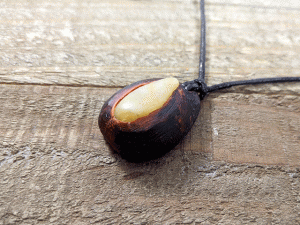 hand-carved avocado stone necklace with tumbled river stone