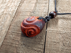 hand-carved avocado stone necklace with double spiral