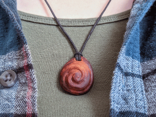 hand-carved avocado stone necklace with double swirl
