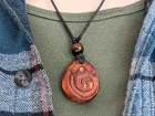 hand-carved avocado stone necklace with fire nation symbol