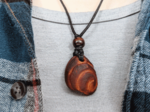 hand-carved avocado stone necklace with spiral pattern