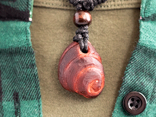 hand-carved avocado stone necklace with spiral