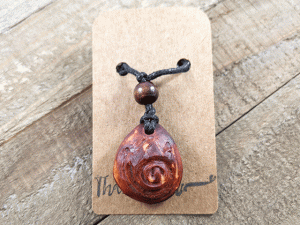 hand-carved avocado stone necklace with fire nation symbol