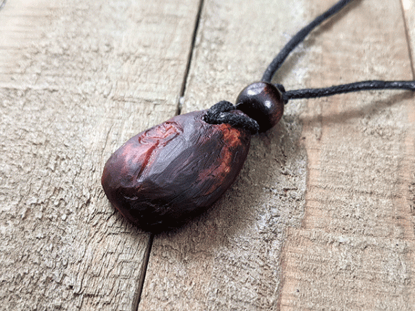 hand-carved avocado stone necklace with leaf design