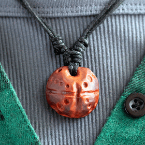 hand-carved avocado stone necklace with dots design