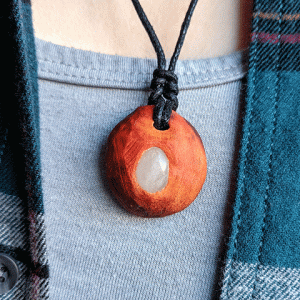 hand-carved avocado stone necklace with milky quartz