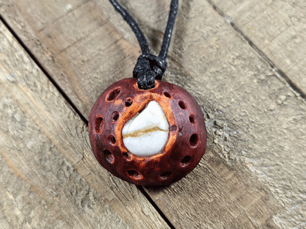 hand-carved avocado stone necklace with tumbled tear drop river stone