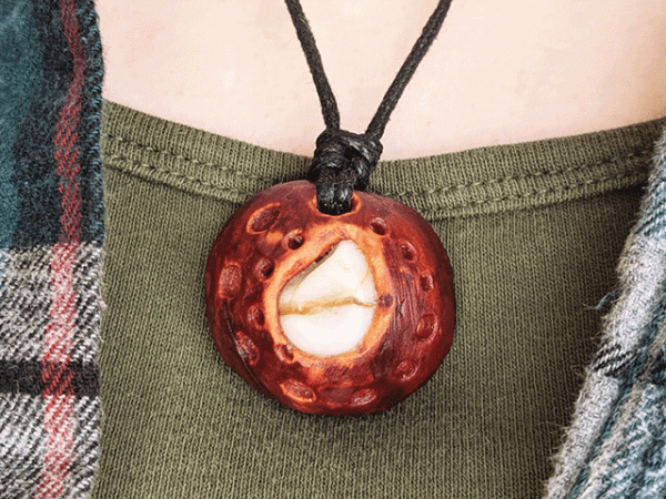 hand-carved avocado stone necklace with tumbled tear drop river stone