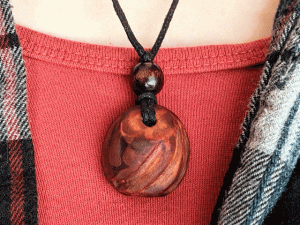 hand-carved avocado stone necklace with triple slash pattern