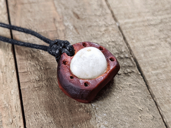 hand-carved avocado stone necklace with white tumbled river stone