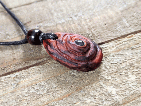 hand-carved avocado stone necklace with red garnet gemstone