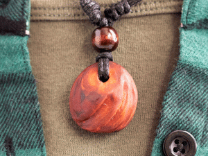 hand-carved avocado stone necklace with slashed pattern