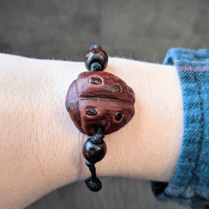 hand-carved avocado stone ladybug bracelet