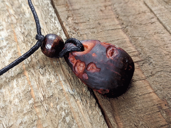 hand carved avocado stone necklace with rose pattern
