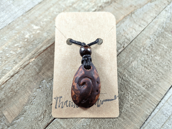 hand-carved avocado stone necklace with bass clef