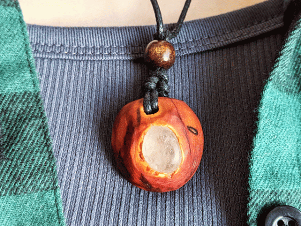 hand-carved avocado stone necklace with milky quartz