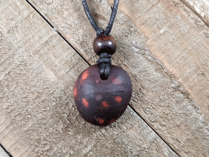 hand-carved avocado stone necklace with spotted pattern