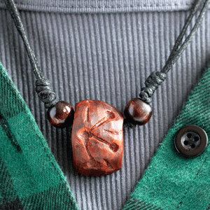 hand-carved avocado stone necklace with snowflake design