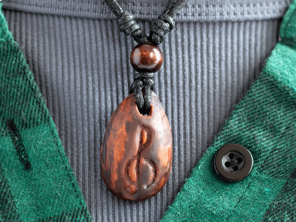 hand-carved avocado stone necklace with treble clef