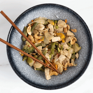 Chris' Cashew Chicken in a blue bowl with chopsticks
