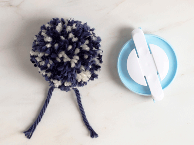how to loom knit a tiny hearts beanie - finished pom pom