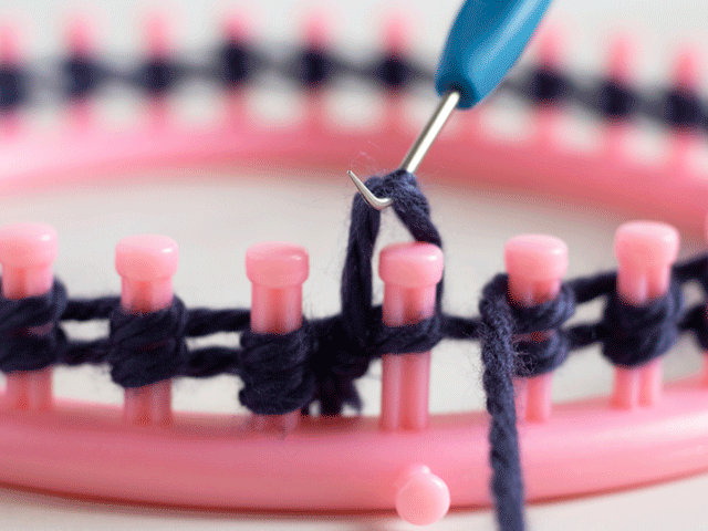 how to loom knit a tiny hearts beanie - lift loop over the peg