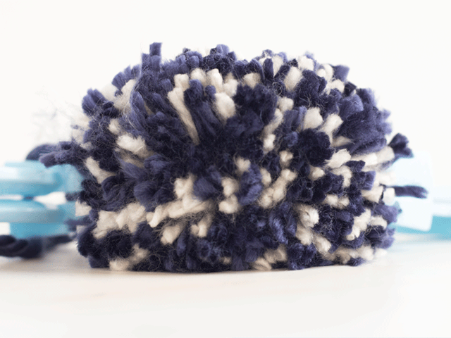 how to loom knit a tiny hearts beanie - remove pom pom maker
