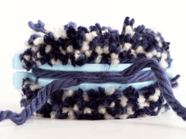 how to loom knit a tiny hearts beanie - tie the pom pom