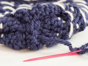 how to loom knit a tiny hearts beanie - tie the top