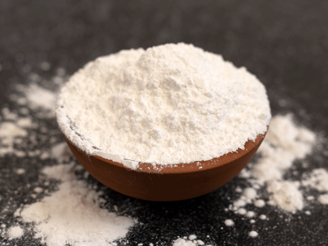 small bowl of baking powder. Learn about baking powder or baking soda in quick bread.
